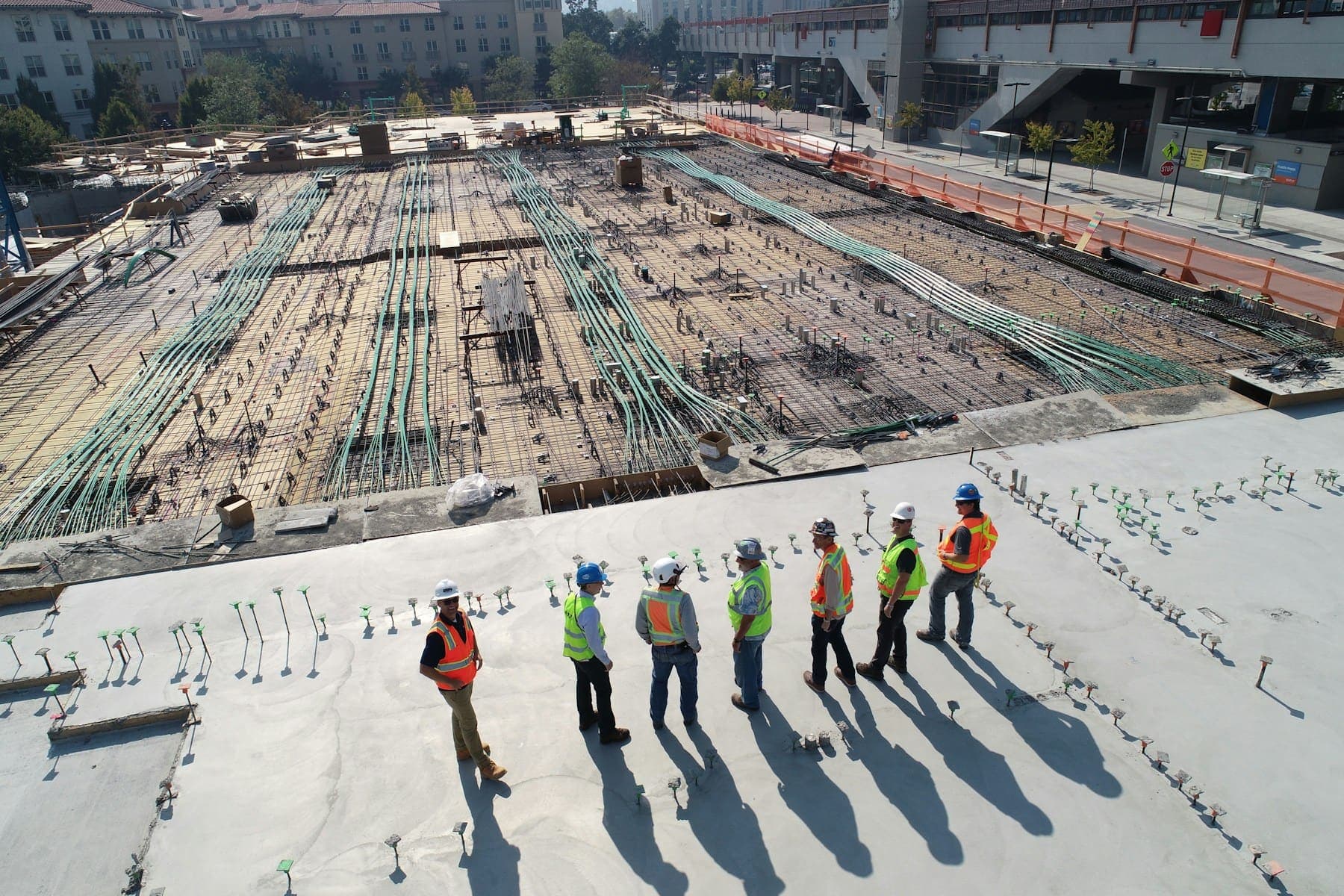 A site crew standing on a freshly poured reinforced slab